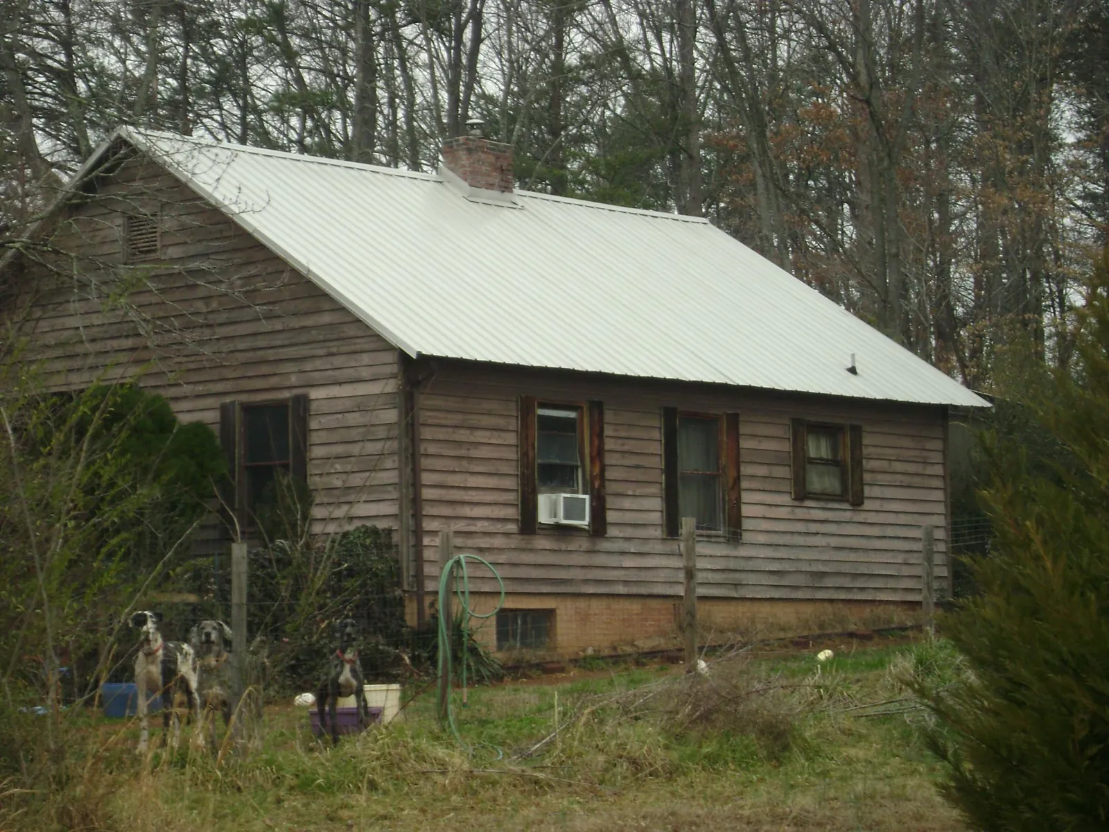 White metal roof on an old wood sided farmhouse, from a Metal Roof Installation job in Tintah